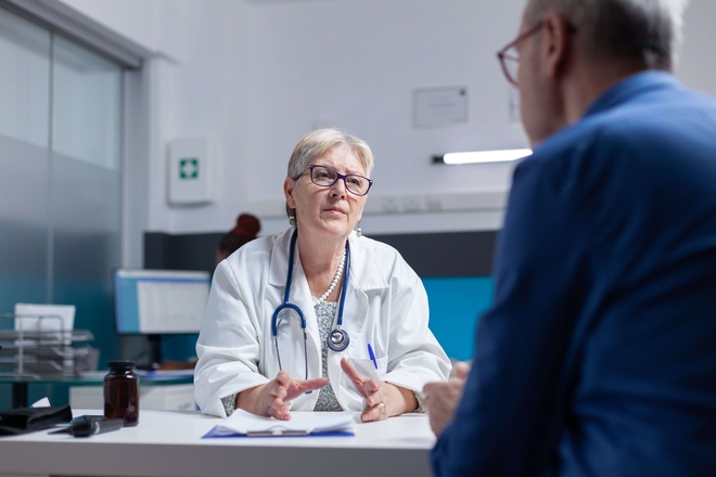 Doctor patient meeting consultation appointment healthcare checkup cabinet medic talking aged man about diagnosis treatment after examination medical visit min